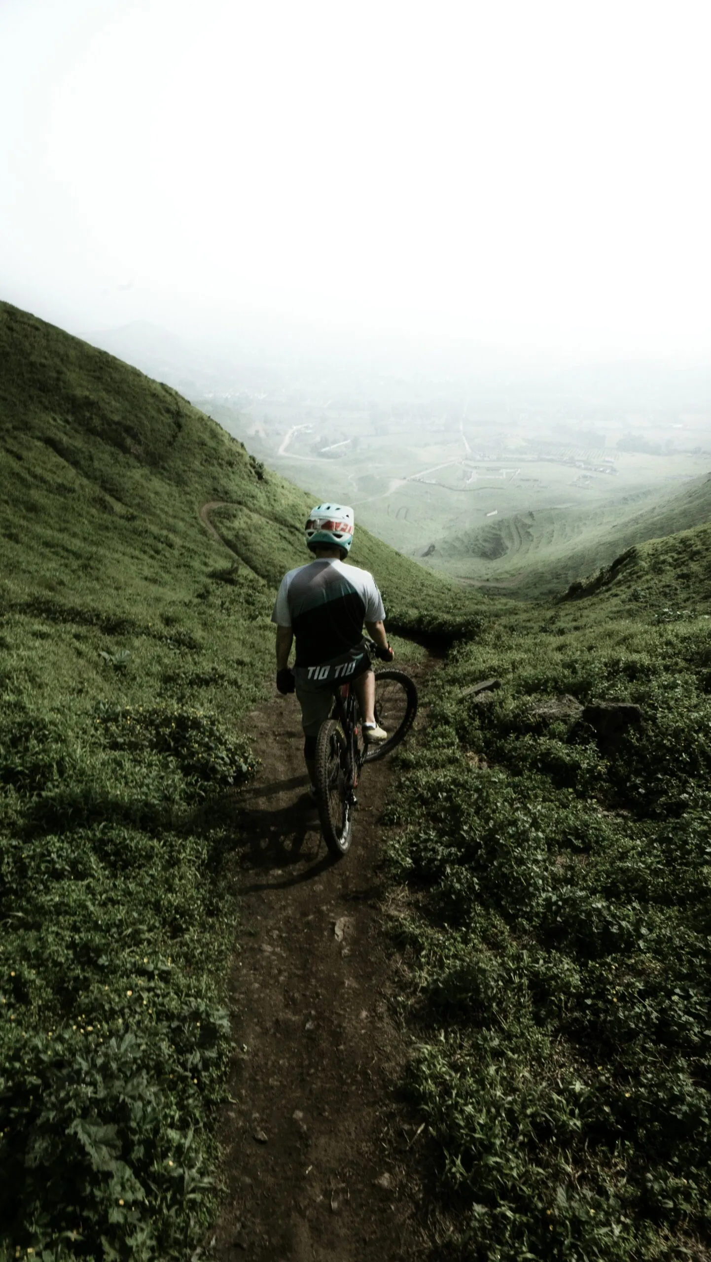 Mountain biker on a trail with Lake Garda views